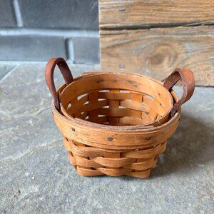 Super small round Longaberger basket with leather handles.